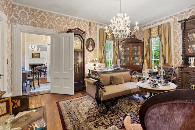 18 High St, Wiscasset, ME 04578 - living area with wallpapered walls, a chandelier, hardwood / wood-style floors, and crown molding
