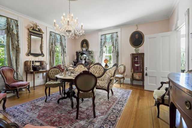 18 High St, Wiscasset, ME 04578 - dining area with a chandelier, light wood-style flooring, and crown molding