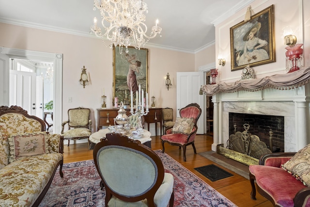 18 High St, Wiscasset, ME 04578 - living room featuring wood finished floors, crown molding, a chandelier, and a premium fireplace