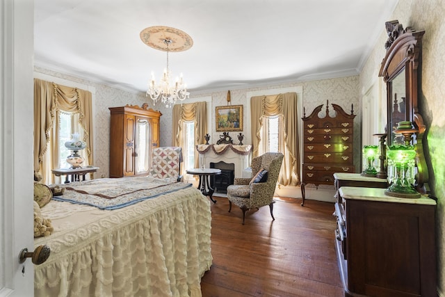 18 High St, Wiscasset, ME 04578 - bedroom featuring wallpapered walls, crown molding, multiple windows, a chandelier, and dark wood-type flooring