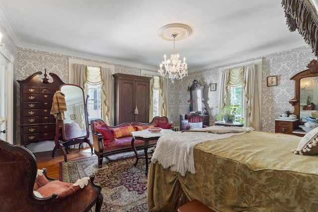 18 High St, Wiscasset, ME 04578 - bedroom featuring wallpapered walls, crown molding, a chandelier, and wood finished floors