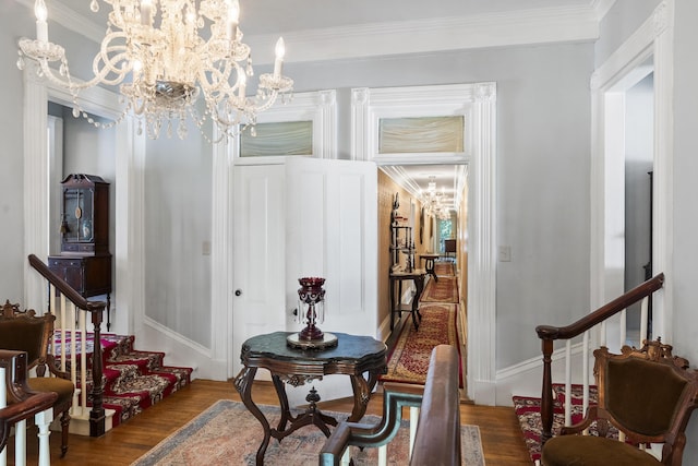 18 High St, Wiscasset, ME 04578 - dining room with wood finished floors, crown molding, a chandelier, and stairs