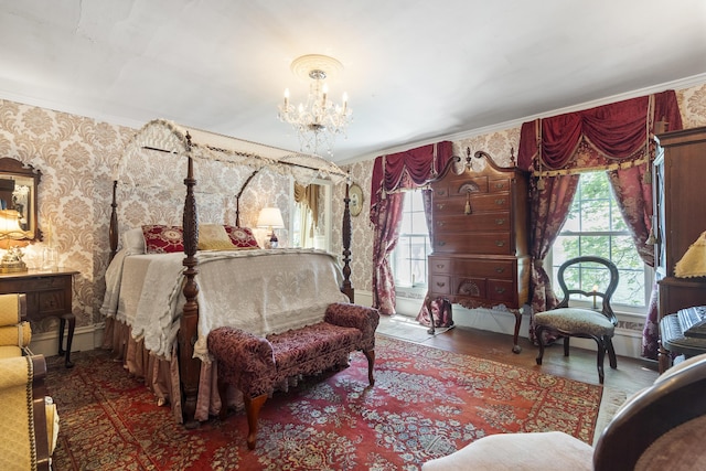 18 High St, Wiscasset, ME 04578 - bedroom with a chandelier, wood finished floors, wallpapered walls, and crown molding