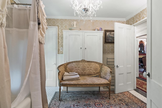 18 High St, Wiscasset, ME 04578 - living area featuring wallpapered walls, a chandelier, and a wainscoted wall