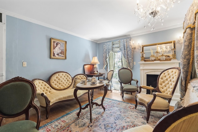 18 High St, Wiscasset, ME 04578 - living area featuring wood finished floors, a chandelier, crown molding, and a fireplace