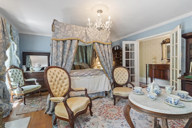 18 High St, Wiscasset, ME 04578 - bedroom with wood finished floors, a chandelier, and crown molding