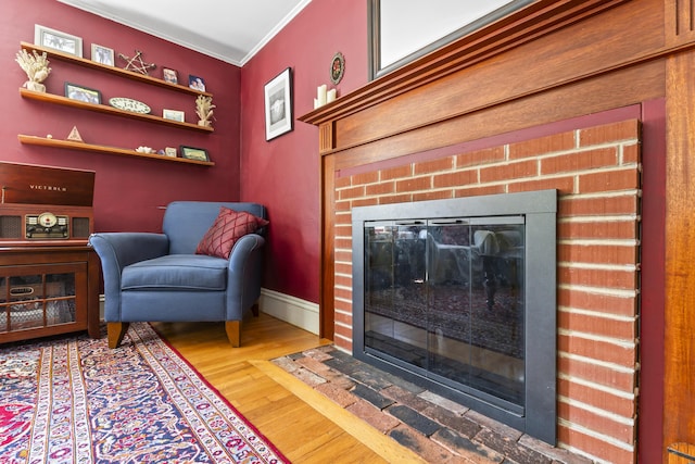 141 Centre St, Bath, ME 04530 - living area featuring a brick fireplace, wood finished floors, and ornamental molding