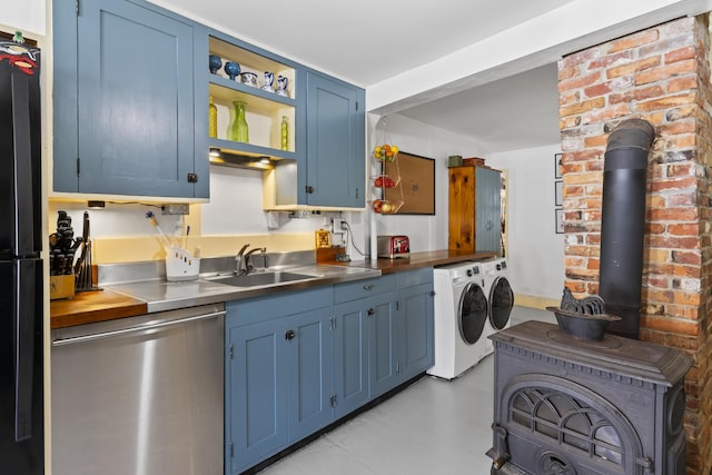 141 Centre St, Bath, ME 04530 - kitchen with stainless steel dishwasher, independent washer and dryer, blue cabinetry, freestanding refrigerator, and stainless steel countertops