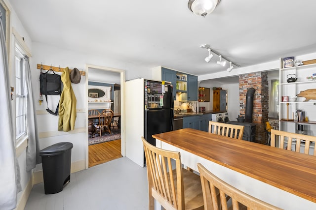 141 Centre St, Bath, ME 04530 - dining room with a wood stove, washer / clothes dryer, and track lighting