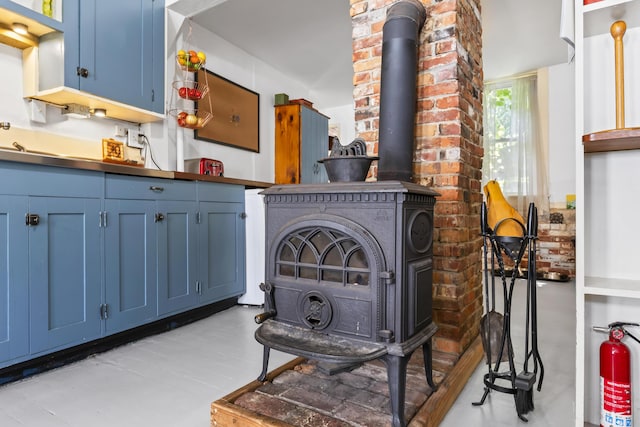 141 Centre St, Bath, ME 04530 - kitchen with blue cabinetry and a wood stove