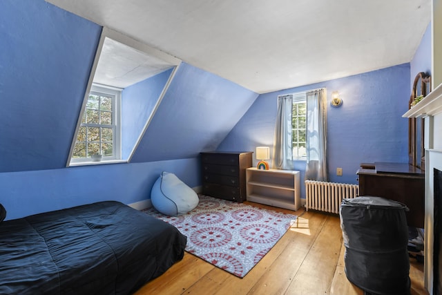 141 Centre St, Bath, ME 04530 - bedroom featuring radiator heating unit, hardwood / wood-style floors, multiple windows, and vaulted ceiling