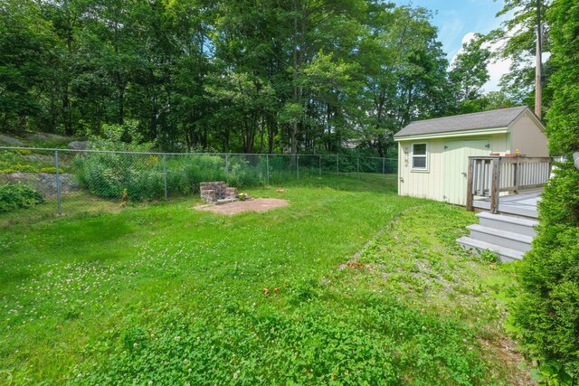 25 Oliver St, Bath, ME 04530 - fenced backyard with a wooden deck and an outbuilding