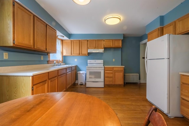 25 Oliver St, Bath, ME 04530 - kitchen featuring white appliances, radiator heating unit, under cabinet range hood, wood finished floors, and light countertops