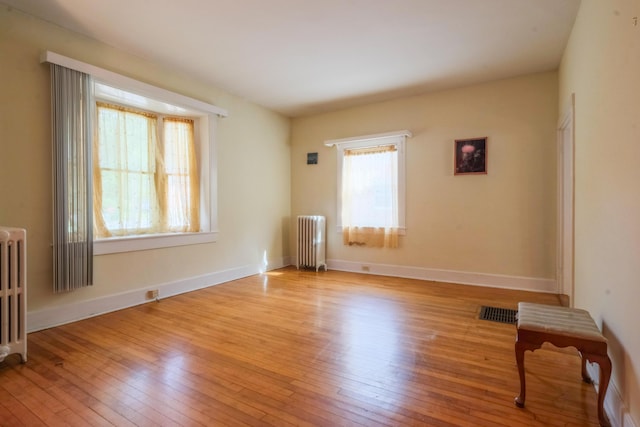 25 Oliver St, Bath, ME 04530 - unfurnished room with radiator and hardwood / wood-style flooring