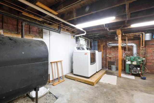 25 Oliver St, Bath, ME 04530 - basement with heating fuel, washing machine and clothes dryer, a heating unit, and brick wall