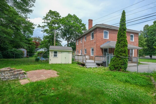 25 Oliver St, Bath, ME 04530 - back of house featuring a shed, a deck, a chimney, and brick siding