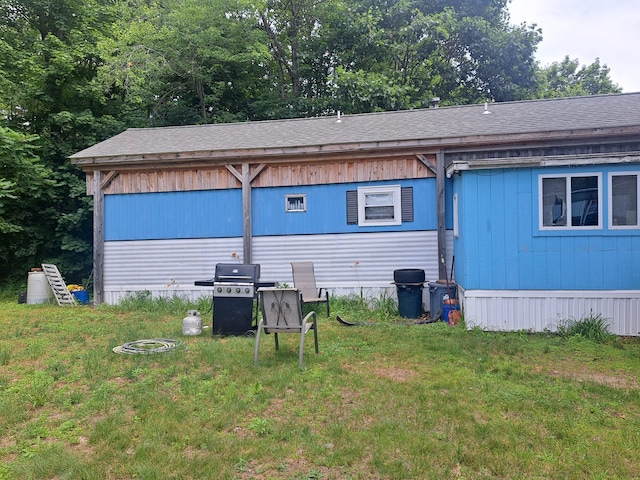 26-28 Addison St, Lisbon, ME 04252 - rear view of property with a shingled roof and a lawn