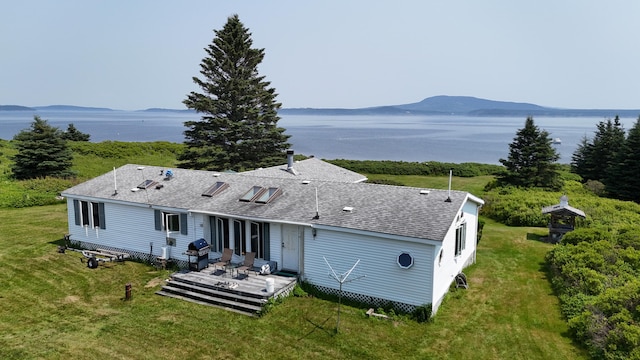 8 Bar Is, Tremont, ME 04674 - rear view of property featuring a deck with water view, roof with shingles, and a yard