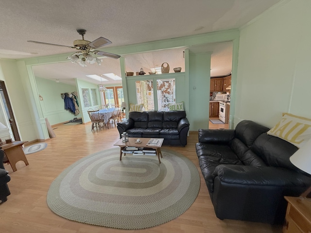 8 Bar Is, Tremont, ME 04674 - living room featuring ceiling fan, light wood-style floors, and a textured ceiling