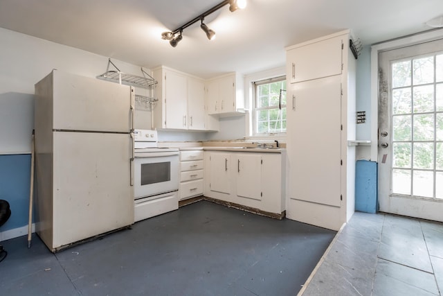 20 Elmwood Ave, Westbrook, ME 04092 - kitchen featuring white appliances, white cabinetry, light countertops, and concrete floors