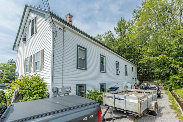 20 Elmwood Ave, Westbrook, ME 04092 - view of side of property featuring a chimney and a vegetable garden