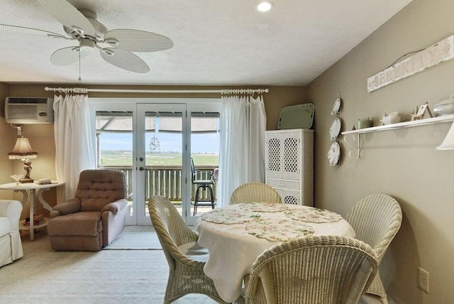 1801 Post Rd Unit 110, Wells, ME 04090 - dining room with french doors, carpet, a wall mounted air conditioner, and a ceiling fan