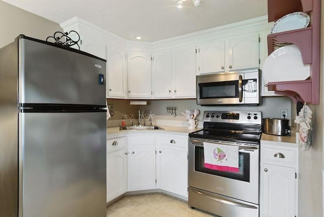 1801 Post Rd Unit 110, Wells, ME 04090 - kitchen with appliances with stainless steel finishes, light countertops, and white cabinetry