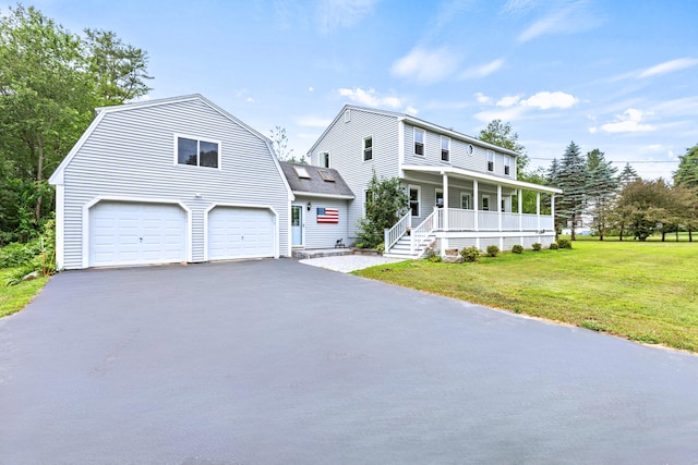 13 Wildbrook Dr, Biddeford, ME 04005 - view of front of home with covered porch, driveway, a front yard, an attached garage, and a gambrel roof