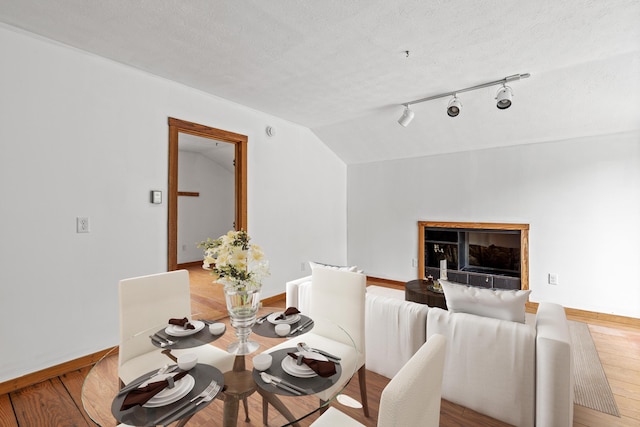 13 Wildbrook Dr, Biddeford, ME 04005 - dining room with vaulted ceiling, light wood-style floors, and a textured ceiling