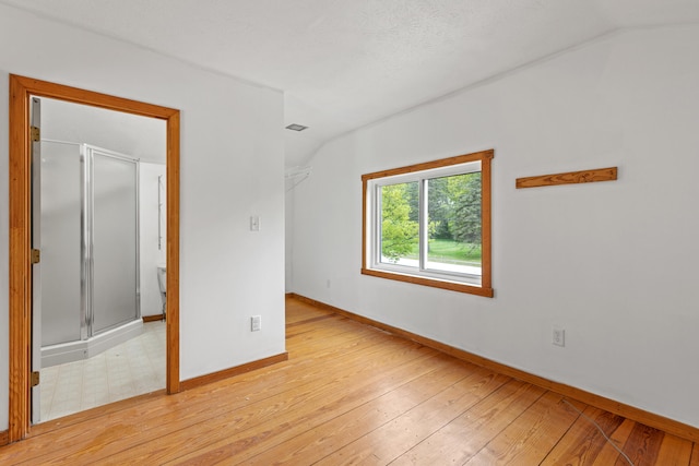 13 Wildbrook Dr, Biddeford, ME 04005 - empty room with light wood finished floors and vaulted ceiling