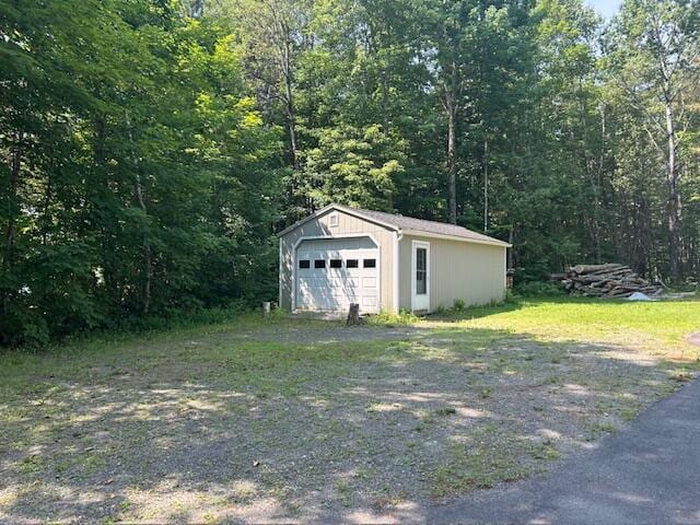 60 Dawes Rd, Dover-Foxcroft, ME 04426 - detached garage featuring a view of trees
