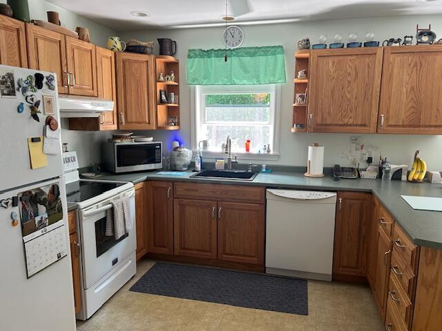 60 Dawes Rd, Dover-Foxcroft, ME 04426 - kitchen featuring white appliances, open shelves, under cabinet range hood, and brown cabinets