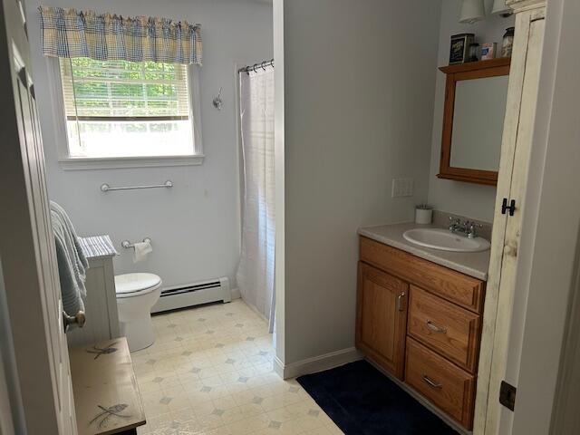 60 Dawes Rd, Dover-Foxcroft, ME 04426 - bathroom with a baseboard radiator, vanity, tile patterned floors, and a shower with shower curtain