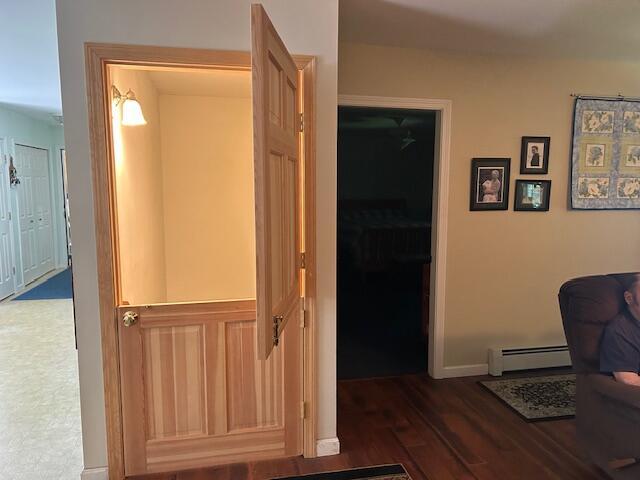 60 Dawes Rd, Dover-Foxcroft, ME 04426 - corridor featuring baseboard heating and wood finished floors