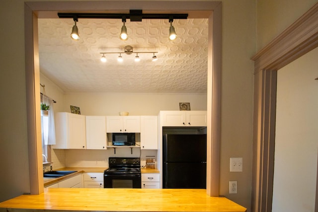 99 Gamage Ave, Auburn, ME 04210 - kitchen featuring black appliances, white cabinets, butcher block counters, and rail lighting