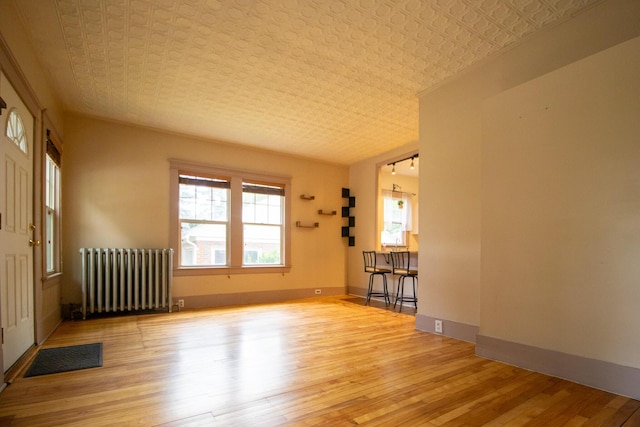 99 Gamage Ave, Auburn, ME 04210 - empty room with radiator and hardwood / wood-style floors