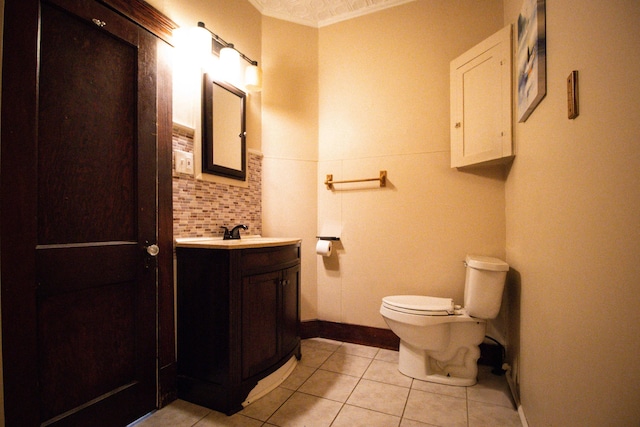 99 Gamage Ave, Auburn, ME 04210 - half bathroom featuring vanity, tile patterned flooring, crown molding, and backsplash