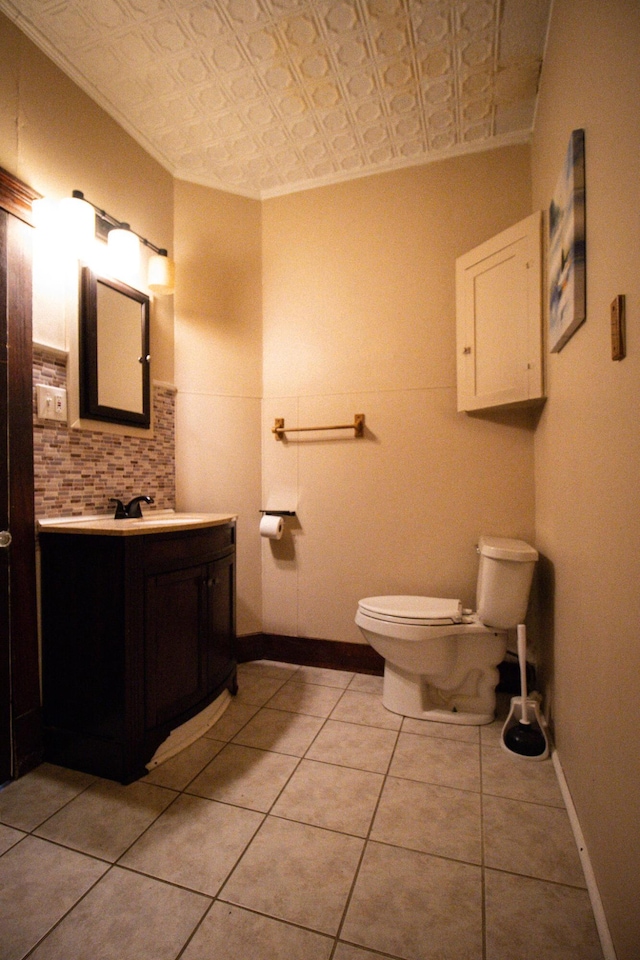 99 Gamage Ave, Auburn, ME 04210 - half bath with an ornate ceiling, vanity, decorative backsplash, tile patterned floors, and crown molding