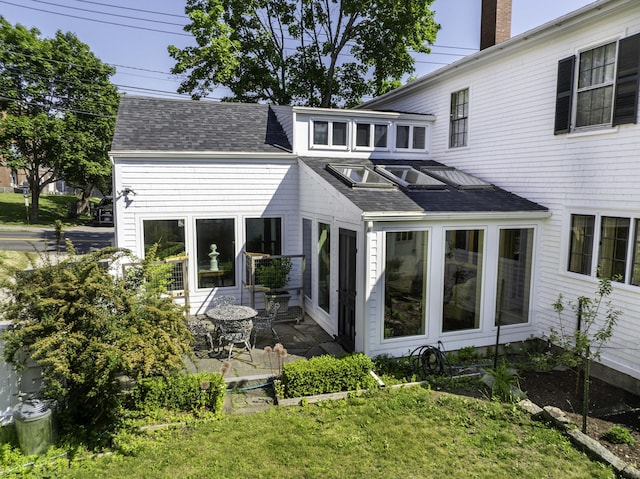 12 Center St, Machias, ME 04654 - rear view of house with a shingled roof and a chimney