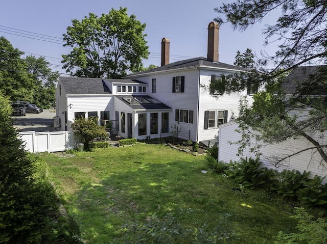 12 Center St, Machias, ME 04654 - back of property featuring a chimney and a sunroom