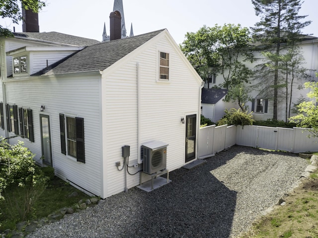 12 Center St, Machias, ME 04654 - view of side of property with roof with shingles, a gate, and a chimney