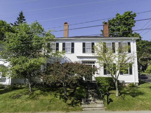 12 Center St, Machias, ME 04654 - colonial-style house featuring a chimney and a front yard