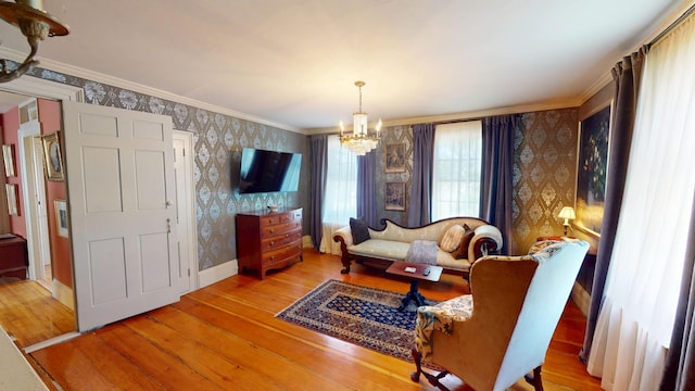 12 Center St, Machias, ME 04654 - living area with wallpapered walls, a chandelier, hardwood / wood-style floors, and ornamental molding