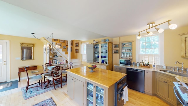 12 Center St, Machias, ME 04654 - kitchen featuring black appliances, light wood finished floors, a kitchen island, and light stone counters