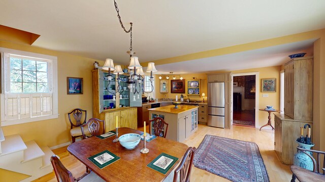 12 Center St, Machias, ME 04654 - dining area with light wood-style flooring and a chandelier