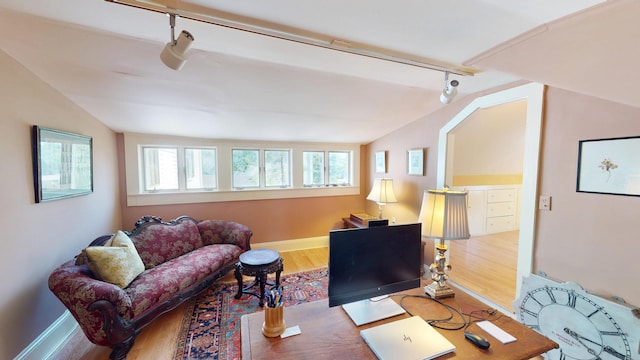12 Center St, Machias, ME 04654 - living area with rail lighting, lofted ceiling, wood finished floors, and healthy amount of natural light