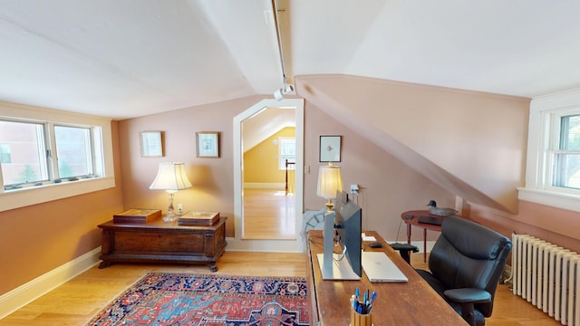 12 Center St, Machias, ME 04654 - home office featuring radiator heating unit, wood finished floors, and lofted ceiling
