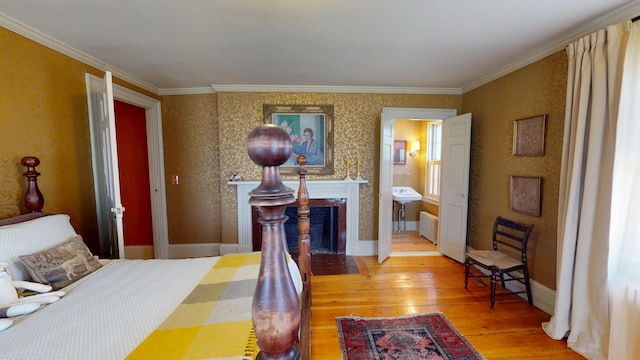 12 Center St, Machias, ME 04654 - bedroom featuring light wood-style flooring, a fireplace with flush hearth, and ornamental molding