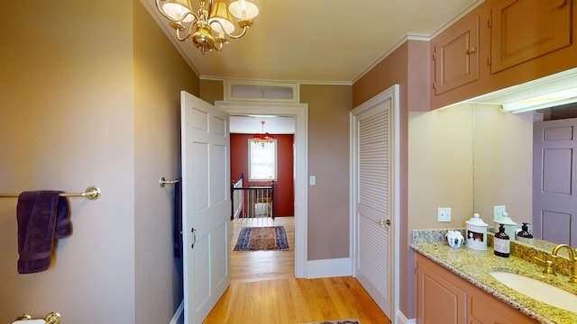 12 Center St, Machias, ME 04654 - bathroom featuring vanity, a chandelier, and wood finished floors