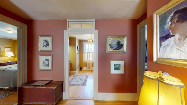 12 Center St, Machias, ME 04654 - hall featuring radiator, wood finished floors, and a chandelier